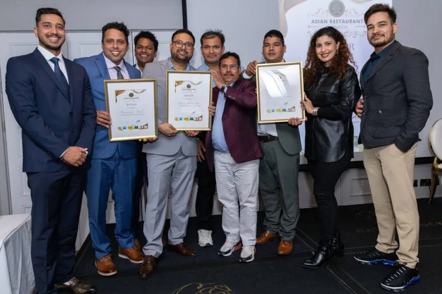 A restaurant team celebrating their win at the Asian Restaurant Awards