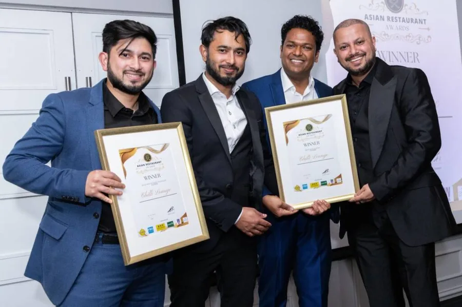 Four winners holding certificates at the Asian Restaurant Awards