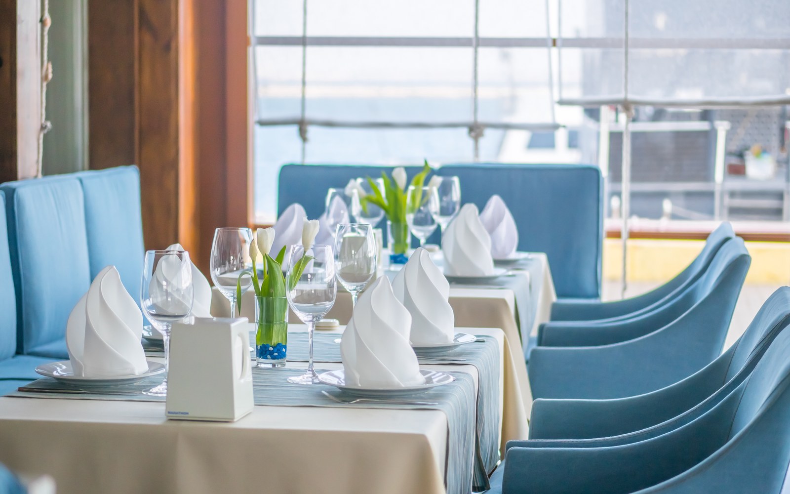 A restaurant table elegantly set with linen and glassware, ready for the next service