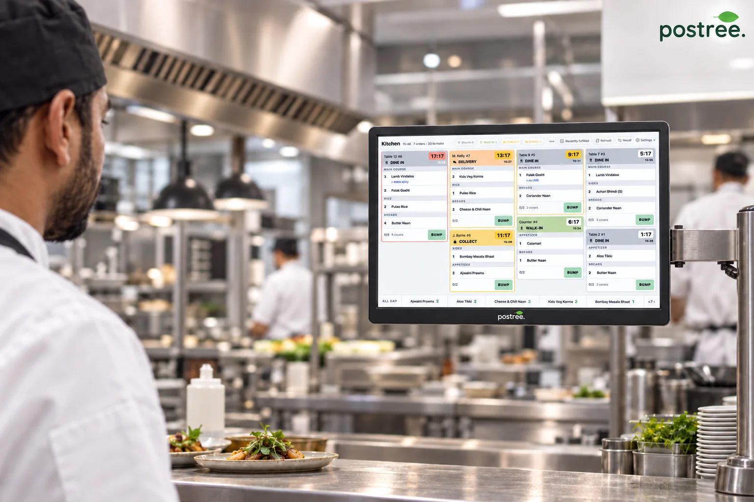 Chef reading live orders on a Postree kitchen display screen in a commercial kitchen