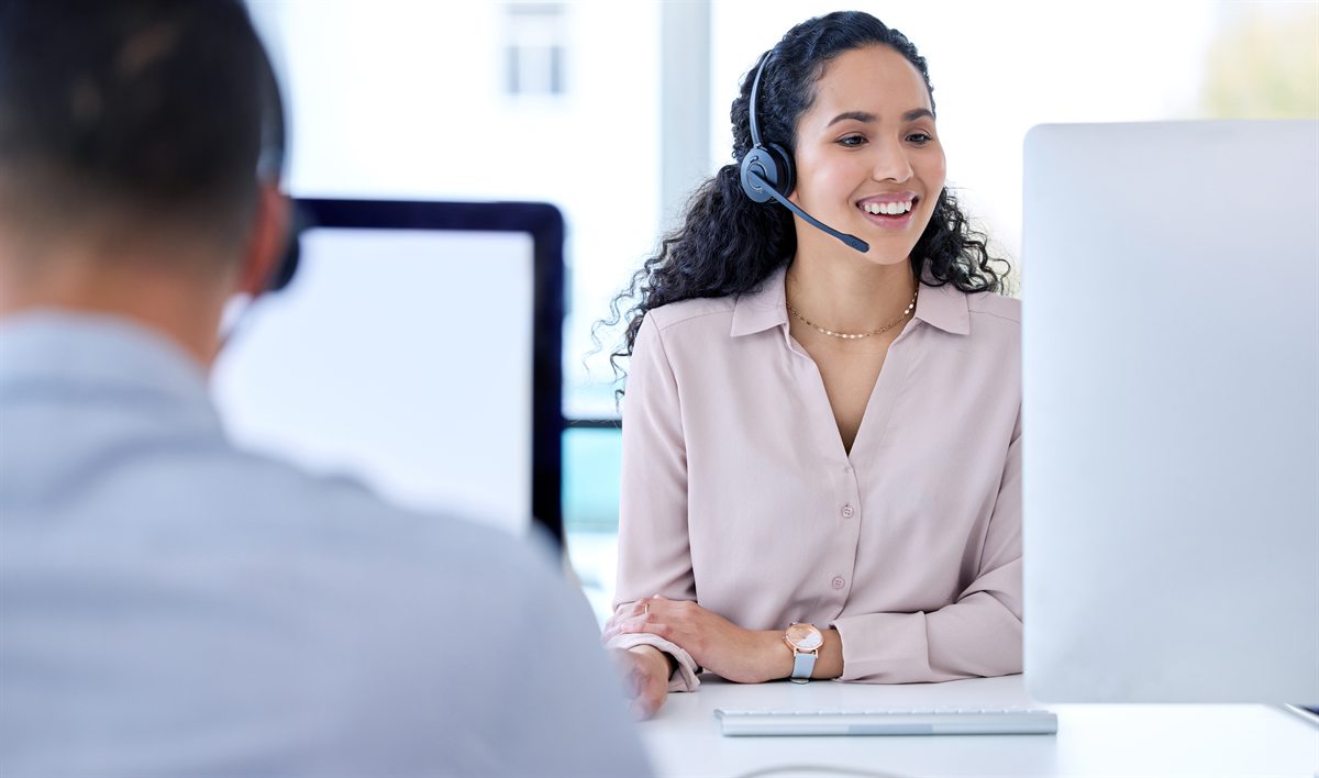 Support agent with a headset helping a customer
