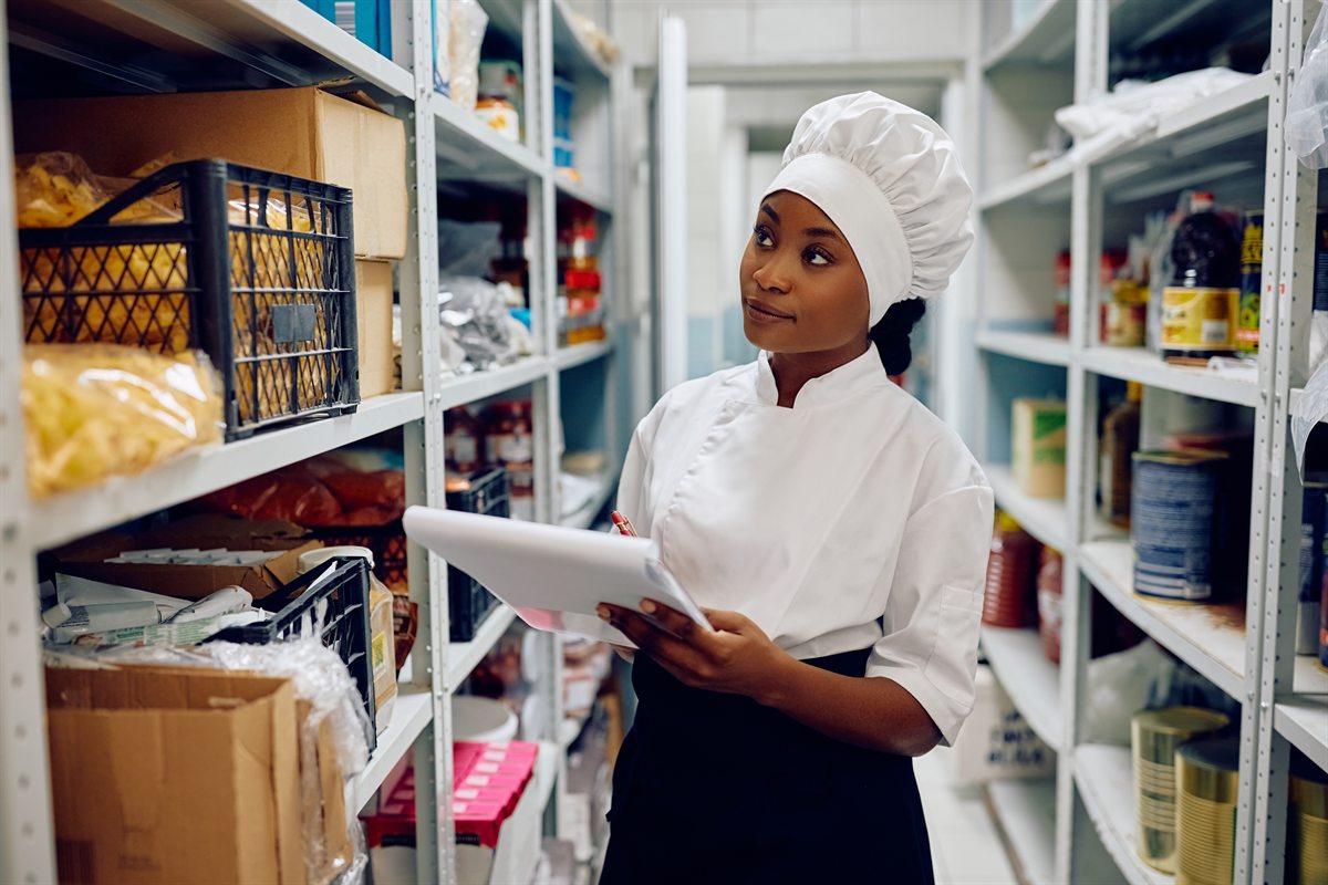 Chef checking grocery stock levels in a restaurant storeroom